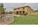 The backyard has a large pool and covered patio with beautiful desert landscaping at 11150 S Star Ct, Goodyear, AZ 85338