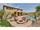 Enjoy outdoor living with a fire pit, swimming pool, and covered patio for year-round enjoyment at 11150 S Star Ct, Goodyear, AZ 85338