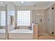 Bathroom with tub, glass block window, and separate shower at 11150 S Star Ct, Goodyear, AZ 85338