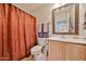 Cozy bathroom with decorative mirror and a matching shower curtain that adds a warm touch at 11150 S Star Ct, Goodyear, AZ 85338