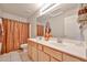 Bathroom features a double sink vanity, a large mirror, neutral walls, and a shower at 11150 S Star Ct, Goodyear, AZ 85338