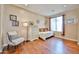 Bright bedroom with hardwood floors, large window, and a daybed for relaxing and enjoying the natural light at 11150 S Star Ct, Goodyear, AZ 85338