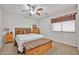 This bedroom features carpet, neutral walls, matching wood furniture, and natural light at 11150 S Star Ct, Goodyear, AZ 85338