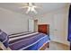 Cozy bedroom featuring a ceiling fan, doors, and a plush bed at 11150 S Star Ct, Goodyear, AZ 85338