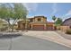 Beautiful two-story home featuring a three-car garage, desert landscaping, and a well-maintained front yard at 11150 S Star Ct, Goodyear, AZ 85338