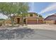 Charming two-story home with a three-car garage, desert landscaping, and a cozy front yard at 11150 S Star Ct, Goodyear, AZ 85338