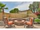 Outdoor fire pit area with comfortable seating, perfect for relaxing and entertaining in the backyard at 11150 S Star Ct, Goodyear, AZ 85338