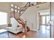 Elegant home foyer featuring a staircase with dark wood rails and a light-filled entryway at 11150 S Star Ct, Goodyear, AZ 85338