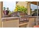 Close up of an outdoor grill with a stainless steel finish, tiled backsplash, and ample counter space at 11150 S Star Ct, Goodyear, AZ 85338