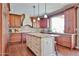 This kitchen has an island with granite counters, a tiled backsplash, wooden cabinets and stainless appliances at 11150 S Star Ct, Goodyear, AZ 85338