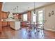 This is a spacious kitchen with wood floors, a center island with granite counters, and wooden cabinets at 11150 S Star Ct, Goodyear, AZ 85338