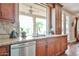 The kitchen sink looks out to a backyard patio with granite countertops and stainless appliances at 11150 S Star Ct, Goodyear, AZ 85338
