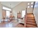 Welcoming living space with lots of natural light, featuring hardwood floors, and an open staircase at 11150 S Star Ct, Goodyear, AZ 85338