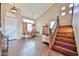 Bright and airy living room featuring a vaulted ceiling, hardwood floors, and staircase at 11150 S Star Ct, Goodyear, AZ 85338