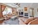This living room has a fireplace, niches, a ceiling fan, and curtains at 11150 S Star Ct, Goodyear, AZ 85338