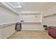 Bright walk-in closet featuring a skylight and built-in shelving and hanging storage solutions at 11150 S Star Ct, Goodyear, AZ 85338