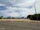 Street view of a large, vacant lot, ideal for building, with city utilities and mature trees at 1137 E 5Th Ave, Mesa, AZ 85204