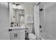 Bathroom features a white vanity, modern fixtures, and a tiled shower with a curtain at 1142 E Westchester Dr, Tempe, AZ 85283
