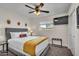 Bright bedroom with a ceiling fan offers a comfortable bed and a mounted TV at 1142 E Westchester Dr, Tempe, AZ 85283