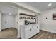 Chic coffee bar area with floating shelves, a beverage center, and stylish white cabinetry at 1142 E Westchester Dr, Tempe, AZ 85283