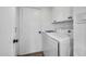 Functional laundry room with a washer, dryer, overhead cabinets, and a door at 1142 E Westchester Dr, Tempe, AZ 85283