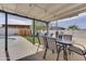 Covered outdoor dining area overlooking an artificial lawn and a sparkling pool at 1209 E Marigold Ln, Tempe, AZ 85288
