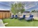 Lounge chairs are situated on artificial grass near an outdoor grill in the backyard at 1209 E Marigold Ln, Tempe, AZ 85288