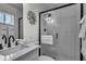 Bathroom featuring a stylish vanity, mirror, and walk-in shower with glass door at 1209 E Marigold Ln, Tempe, AZ 85288
