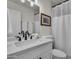 Bathroom with a white vanity, elegant fixtures, and a framed mirror at 1209 E Marigold Ln, Tempe, AZ 85288