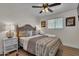 Cozy bedroom features a comfortable bed, ceiling fan, and bedside lamps at 1209 E Marigold Ln, Tempe, AZ 85288