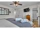Comfortable bedroom featuring a ceiling fan, television, and ensuite bathroom at 1209 E Marigold Ln, Tempe, AZ 85288