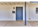 Close-up of a welcoming blue front door with a 'Welcome' mat and stylish hardware at 1209 E Marigold Ln, Tempe, AZ 85288