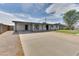 Spacious driveway leading to a home with a covered carport and a modern facade at 1209 E Marigold Ln, Tempe, AZ 85288