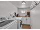 Laundry room with white washer and dryer, wood counter and cabinets, and wood-look floors at 1209 E Marigold Ln, Tempe, AZ 85288