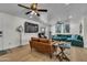 Open concept living area featuring a large television and stylish seating arrangement at 1209 E Marigold Ln, Tempe, AZ 85288