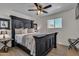 Beautiful main bedroom features decorative pillows, fan, and wood-look tile floors at 1209 E Marigold Ln, Tempe, AZ 85288