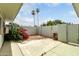 Enclosed backyard with a gravel area, desert landscaping, and a concrete patio area at 13428 N 100Th Ave, Sun City, AZ 85351