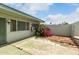 Enclosed backyard with a gravel area, desert landscaping, and a concrete patio area at 13428 N 100Th Ave, Sun City, AZ 85351