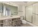 Well-lit bathroom featuring a vanity, toilet, and glass door shower at 13428 N 100Th Ave, Sun City, AZ 85351