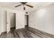 Bedroom featuring wood floors, closet, and ceiling fan at 13428 N 100Th Ave, Sun City, AZ 85351