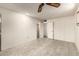 Bright bedroom with tile floors, ceiling fan, and open closet/bathroom door at 13428 N 100Th Ave, Sun City, AZ 85351