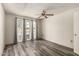 Bright bedroom with new floors, ceiling fan, and natural light from the windows at 13428 N 100Th Ave, Sun City, AZ 85351