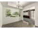 Dining area featuring mural accent wall, tile floors and chandelier lighting at 13428 N 100Th Ave, Sun City, AZ 85351