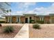 Charming single-story home with a well-maintained front yard and stone accents under a bright blue sky at 13428 N 100Th Ave, Sun City, AZ 85351