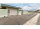 View of the garage and driveway showing the street access, as well as gate to back yard at 13428 N 100Th Ave, Sun City, AZ 85351