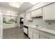 Kitchen and breakfast nook area featuring white cabinets and a kitchen mural at 13428 N 100Th Ave, Sun City, AZ 85351