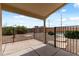 Covered back patio with a fenced gravel yard area and access to the swimming pool at 13438 N 130Th Ln, El Mirage, AZ 85335