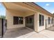 A covered patio with a large sliding glass door that opens to the backyard at 13438 N 130Th Ln, El Mirage, AZ 85335