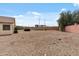 Large backyard with gravel landscaping, a pool, and a privacy wall at 13438 N 130Th Ln, El Mirage, AZ 85335
