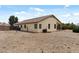 Spacious gravel backyard featuring a covered patio and well-maintained landscaping at 13438 N 130Th Ln, El Mirage, AZ 85335
